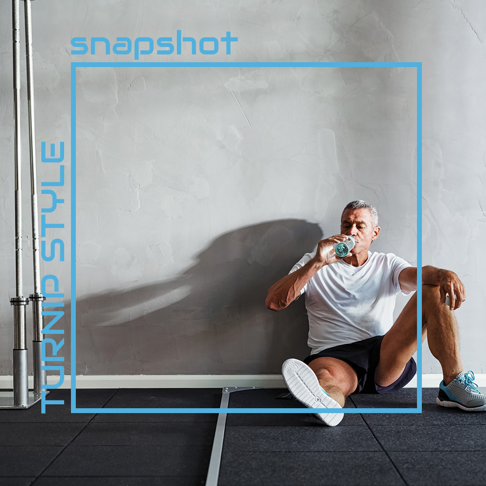 mature gentleman drinking water after a workout - sadly we cant quite see up his shorts...