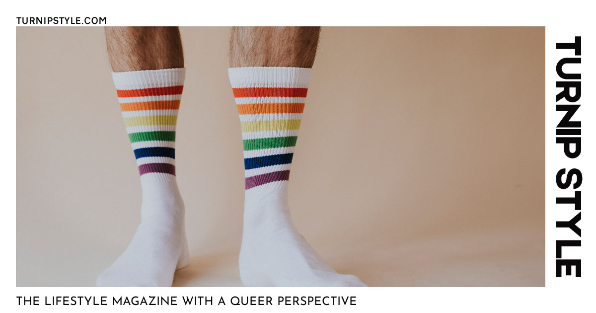 A man in socks with stripes in the colour of the rainbow