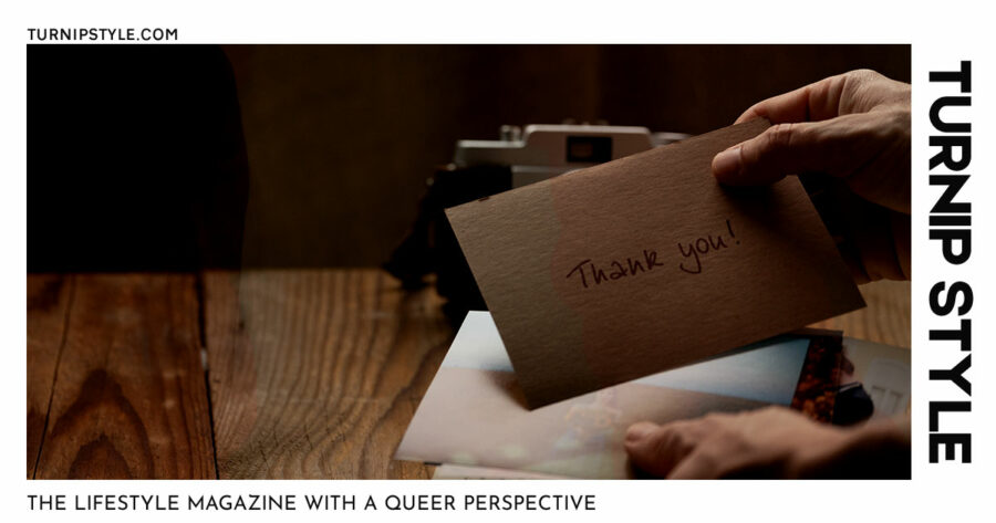 A man holding a thank you card