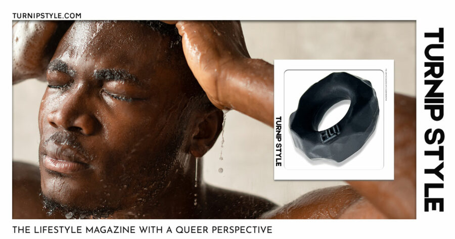 Man taking a shower and washing his hair with his eyes closed and image of the Fractal Comfort cockring is imposed over the image of the man.